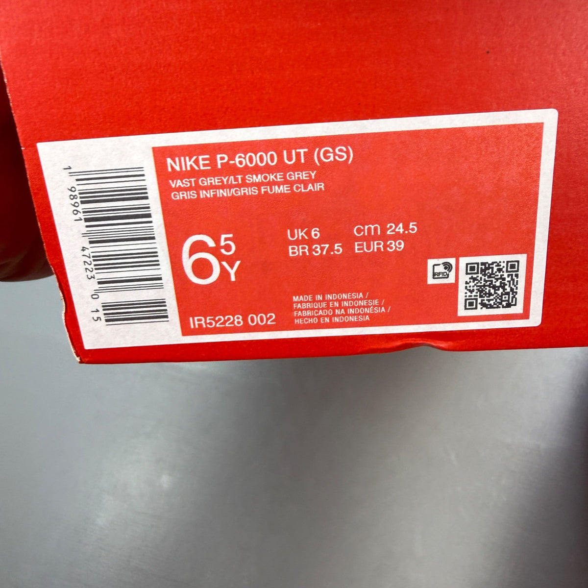 Nike deck shoes silver with logo details and sleek design.