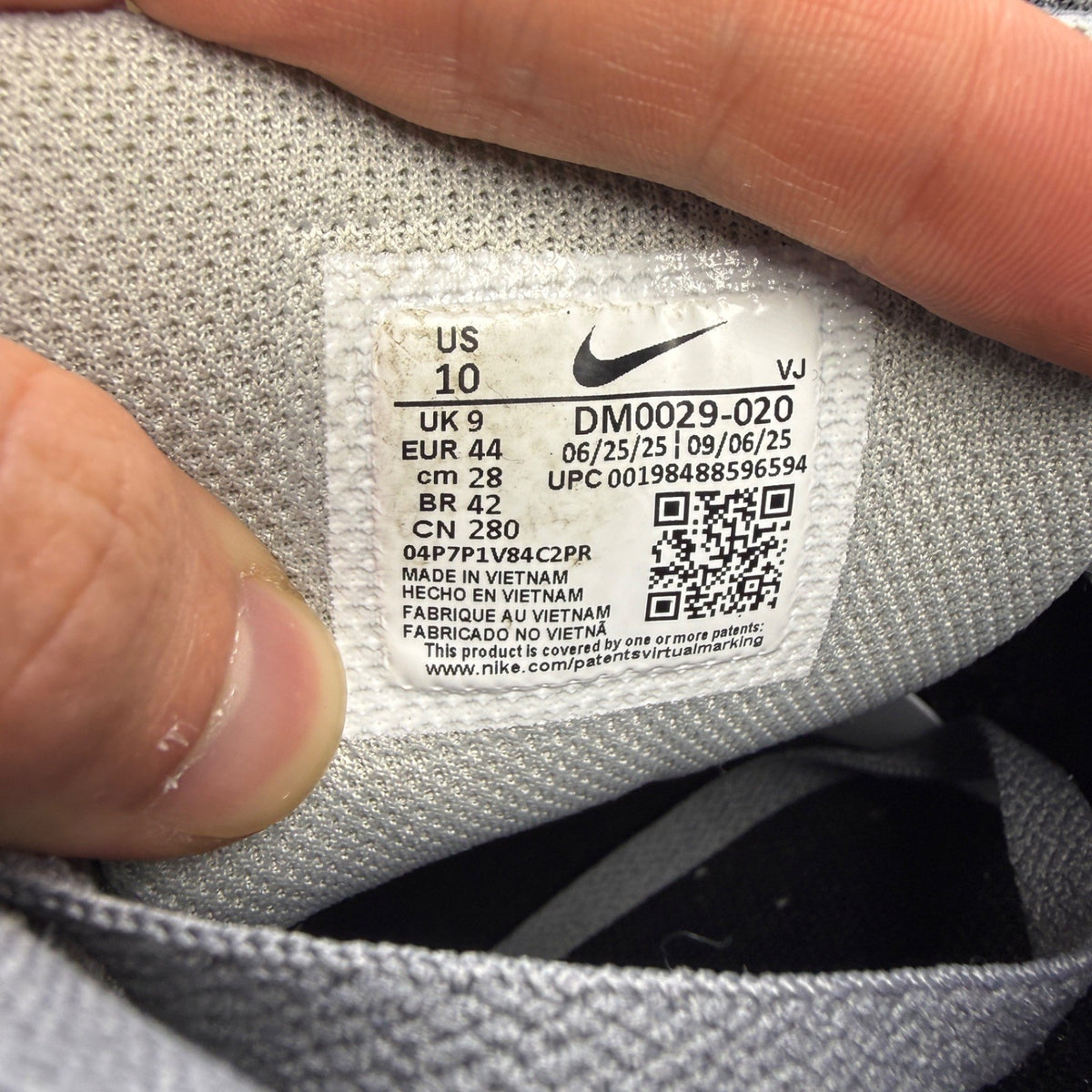 Nike trainers grey with black accents and logo, featuring a sleek design and breathable material.