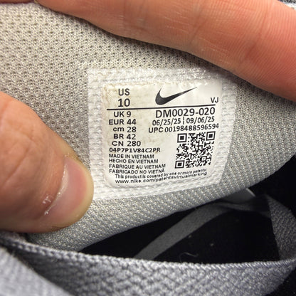 Nike trainers grey with black accents and logo, featuring a sleek design and breathable material.