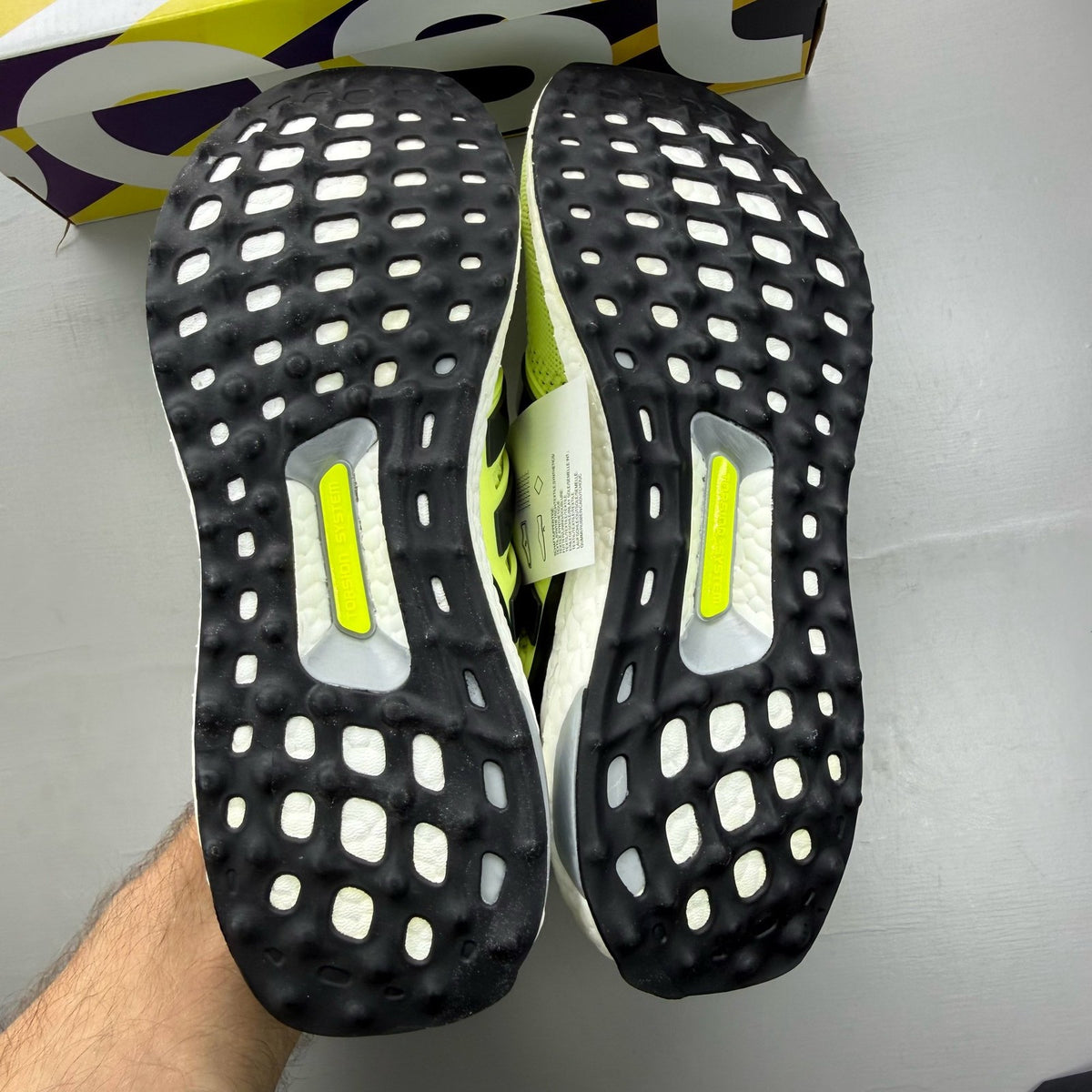 Adidas UltraBoost 1.0 yellow trainers with black and white accents, mesh upper.