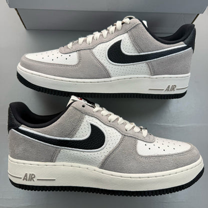 Nike Air Force 1 grey trainers with black accents and signature swoosh logo.