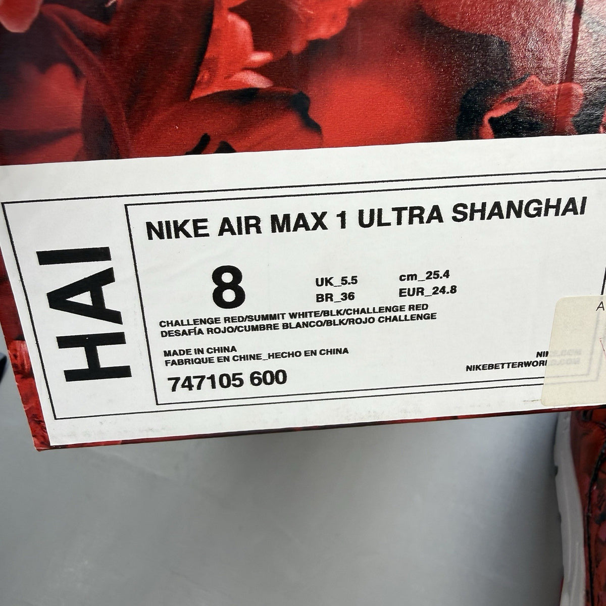 Nike Air Max 1 red trainers with white accents and classic logo detail.