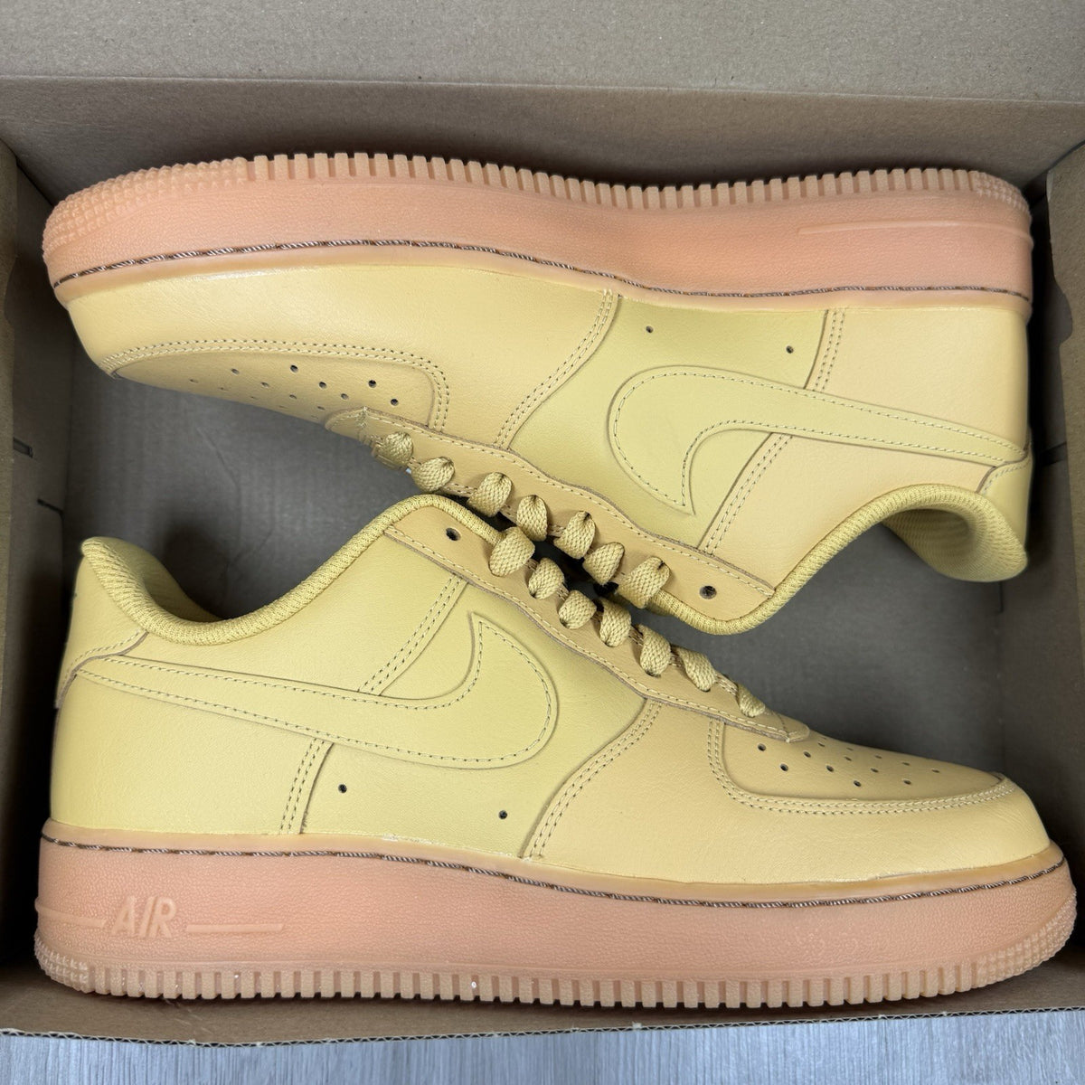 Nike Air Force 1 trainers brown suede upper with gum sole and logo detail.