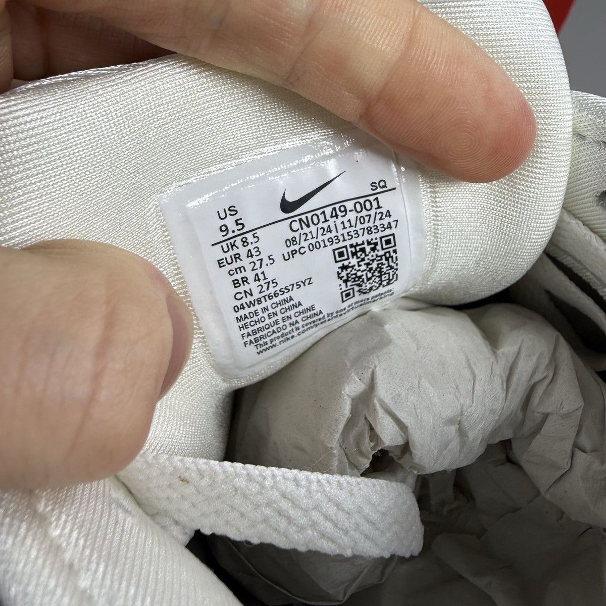 Nike P-6000 metallic silver trainers with black accents and white detailing.