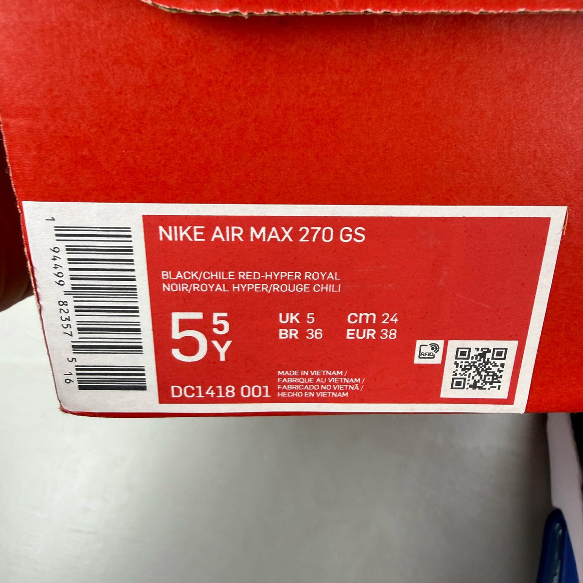Nike black Air Max 270 trainers with blue accents and logo detail.