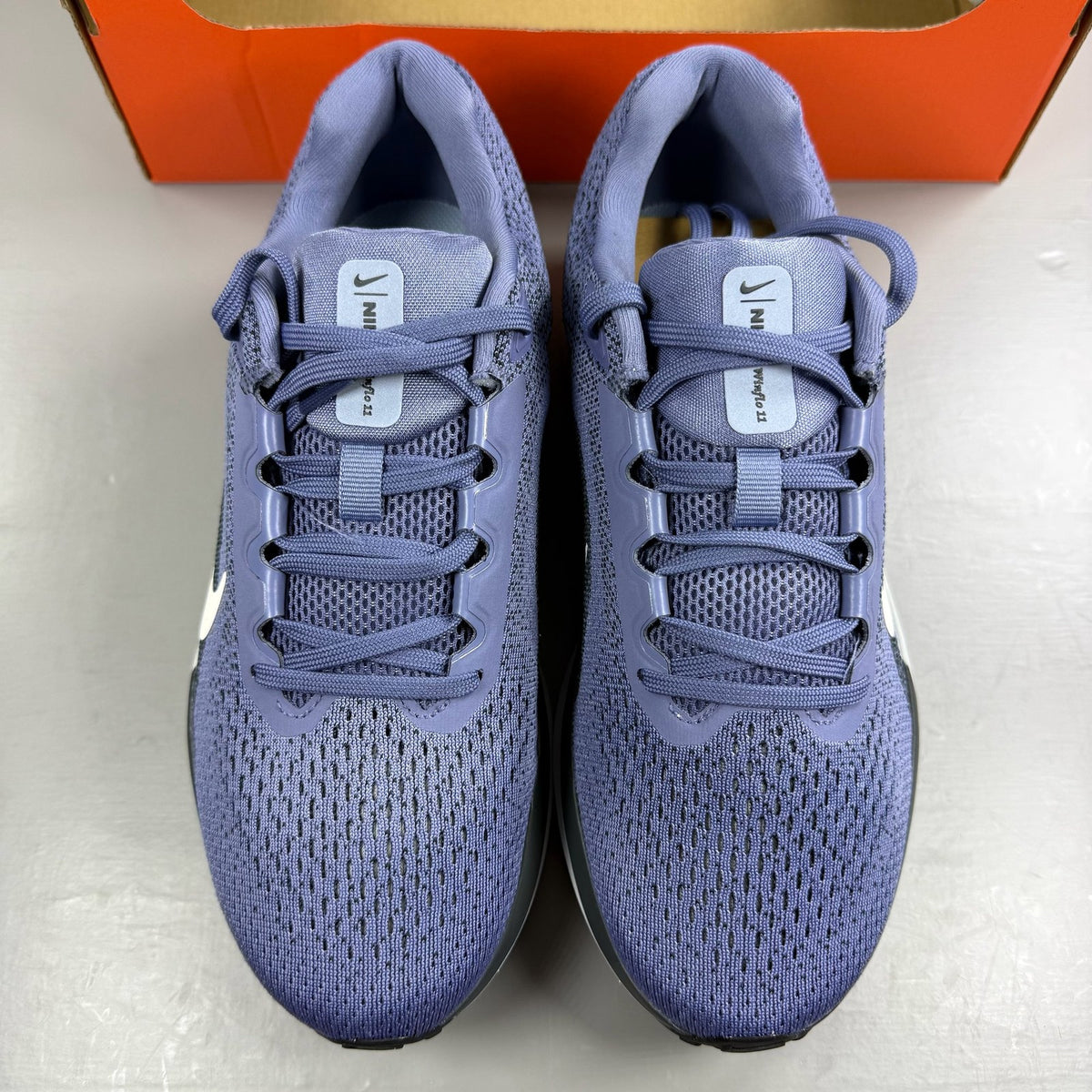 Nike blue trainers with mesh upper and swoosh logo, size UK 6.
