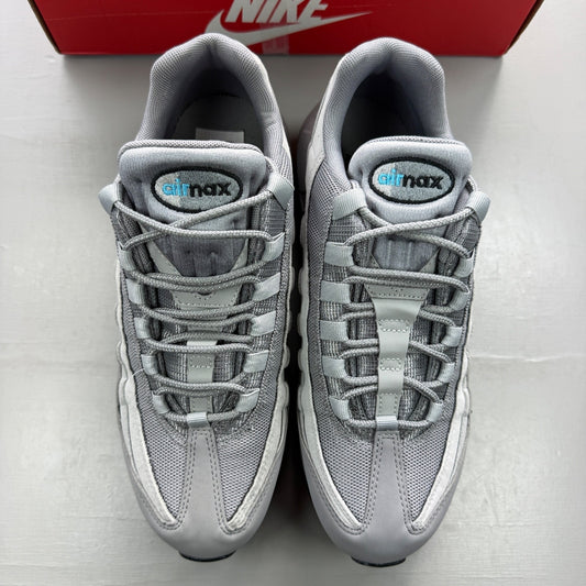 Nike grey trainers with aqua accents and retro logo detailing.