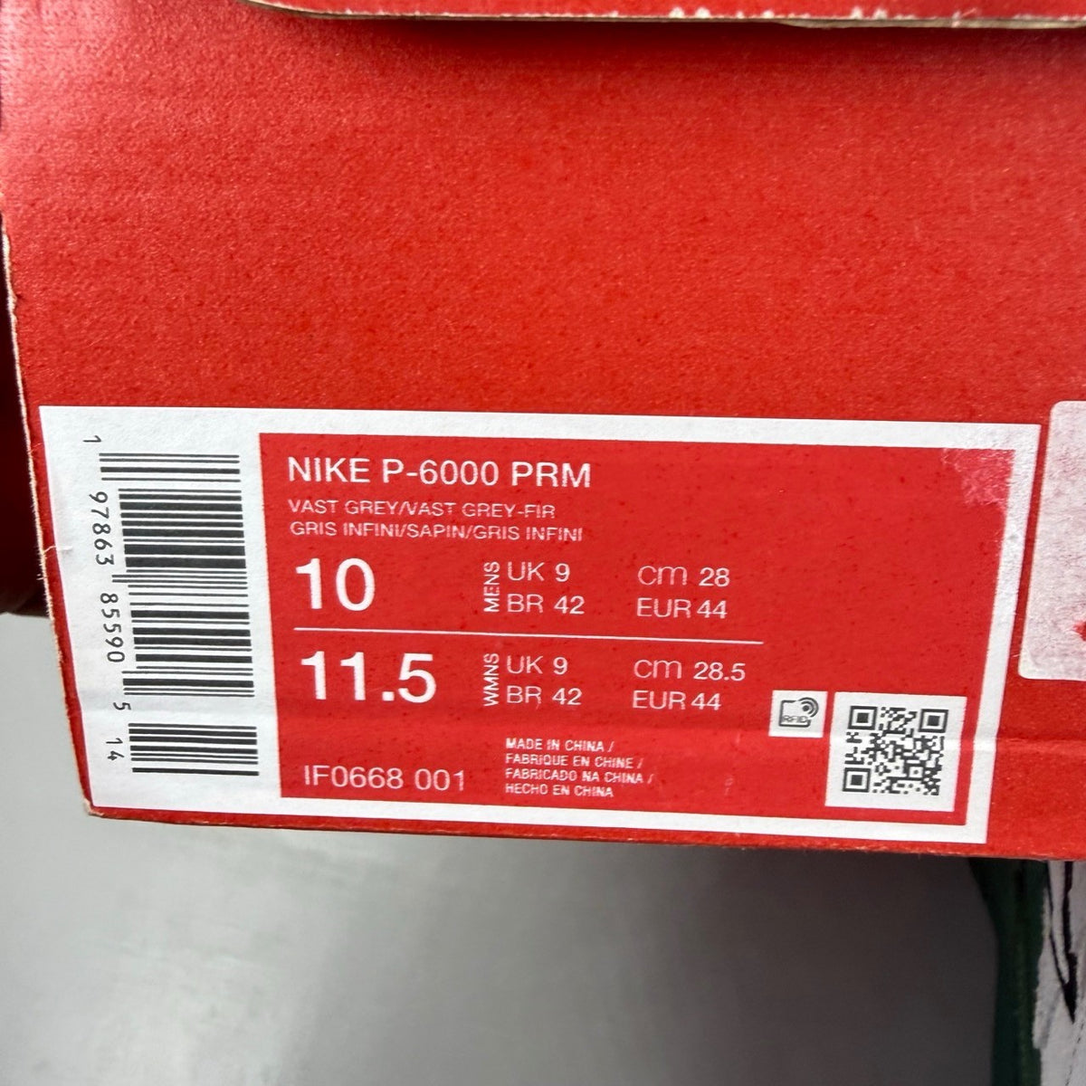Nike P-6000 grey trainers with mesh upper and signature swoosh logo.