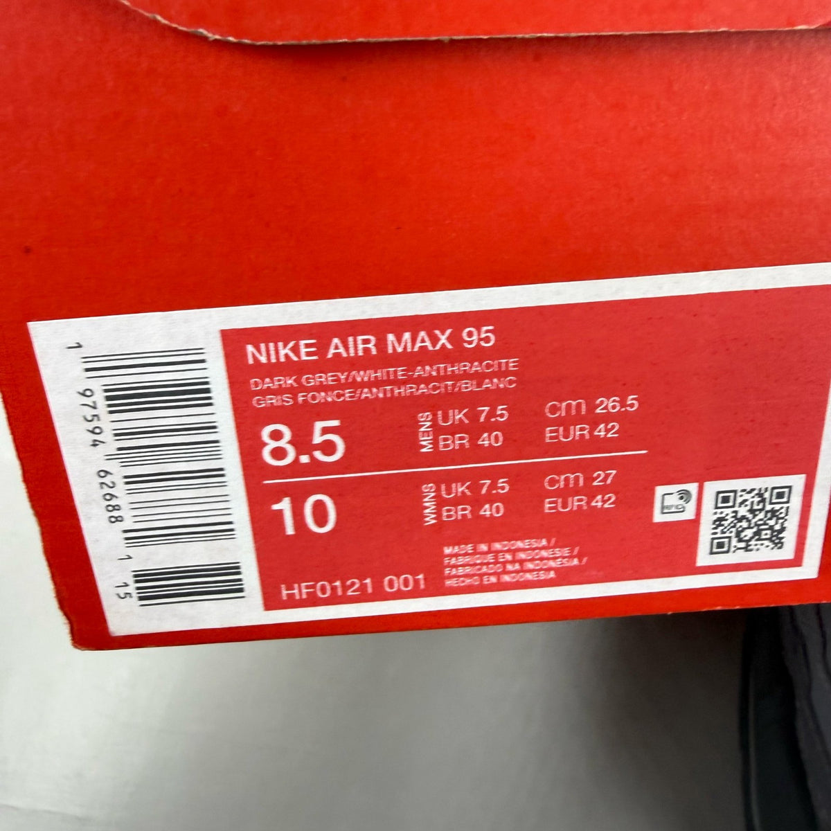 Nike Air Max 95 grey trainers with distinctive design and logo details.