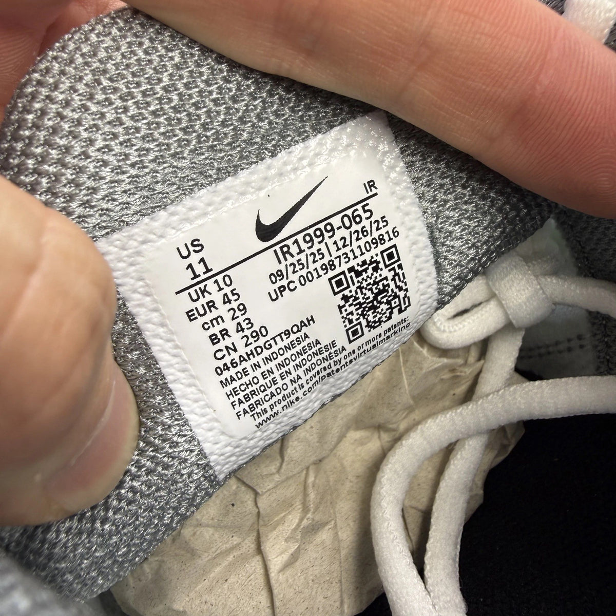 Nike Air Max Plus TN grey trainers with white and liquid lime accents, logo detail.