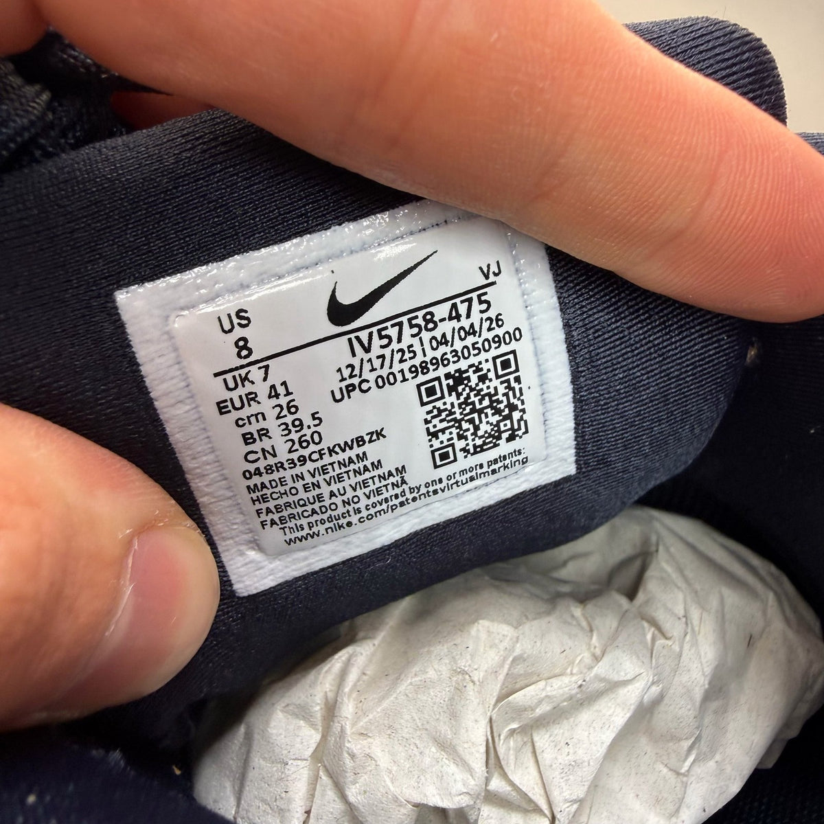 Nike Air Max 90 blue trainers with white accents and logo detail.