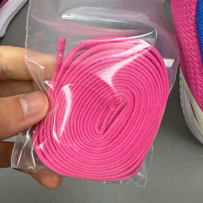 Adidas ZX Flux trainers in shock pink with black and blue accents, mesh upper.