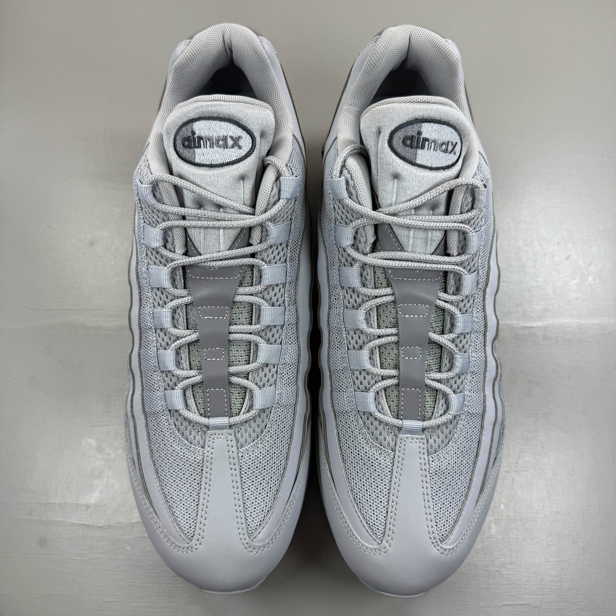 Nike Air Max 95 white trainers with big bubble sole and reflective detailing.