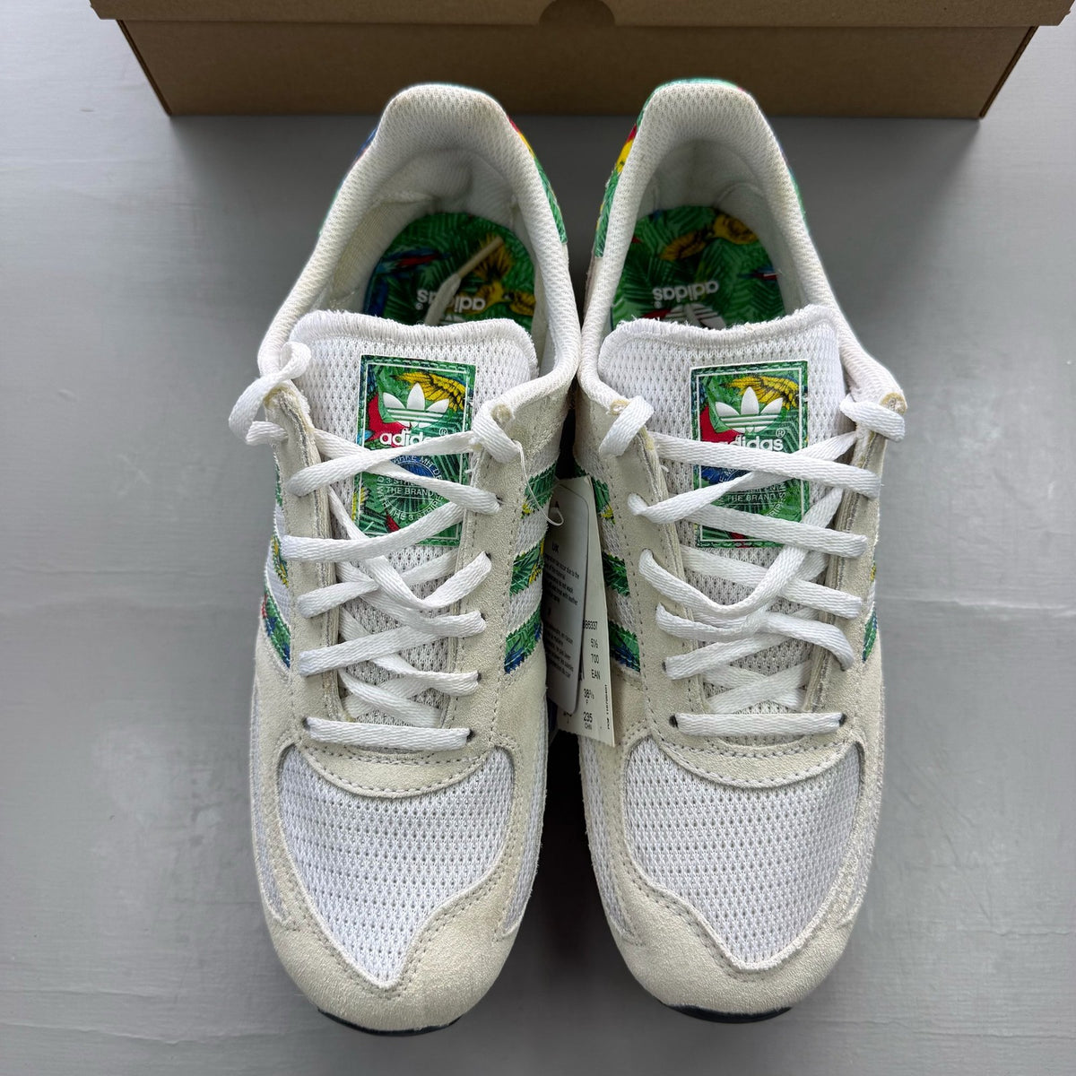 Adidas white LA Trainer with tropical pattern and logo detail on the side.