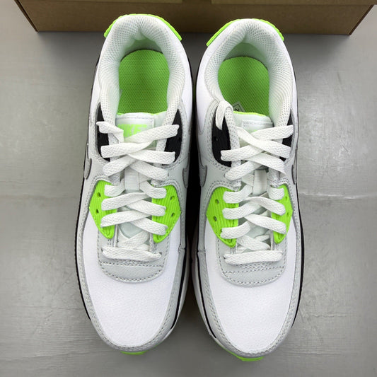 Nike Air Max 90 white trainers with black and lime blast accents, featuring iconic logo.