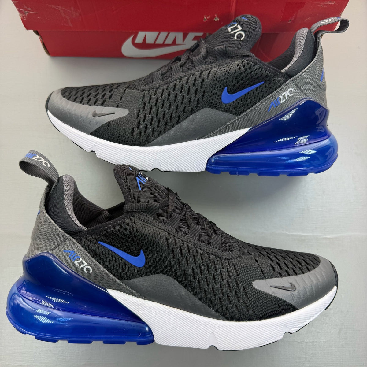 Nike Air Max 270 black trainers with game royal and white accents, mesh upper.