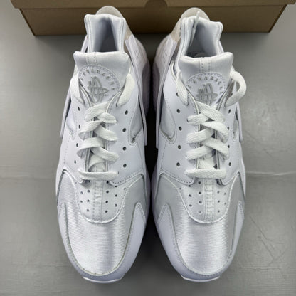 Nike Air Huarache white trainers with Pure Platinum accents and signature logo details.