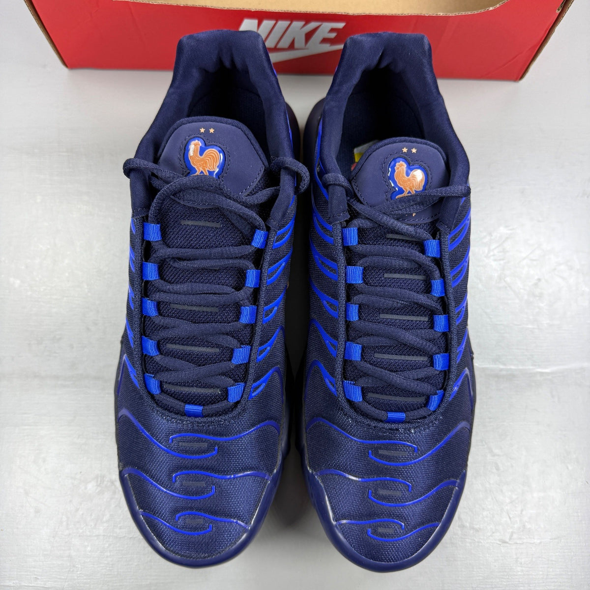 Nike running shoes metallic blue with copper accents and signature logo.