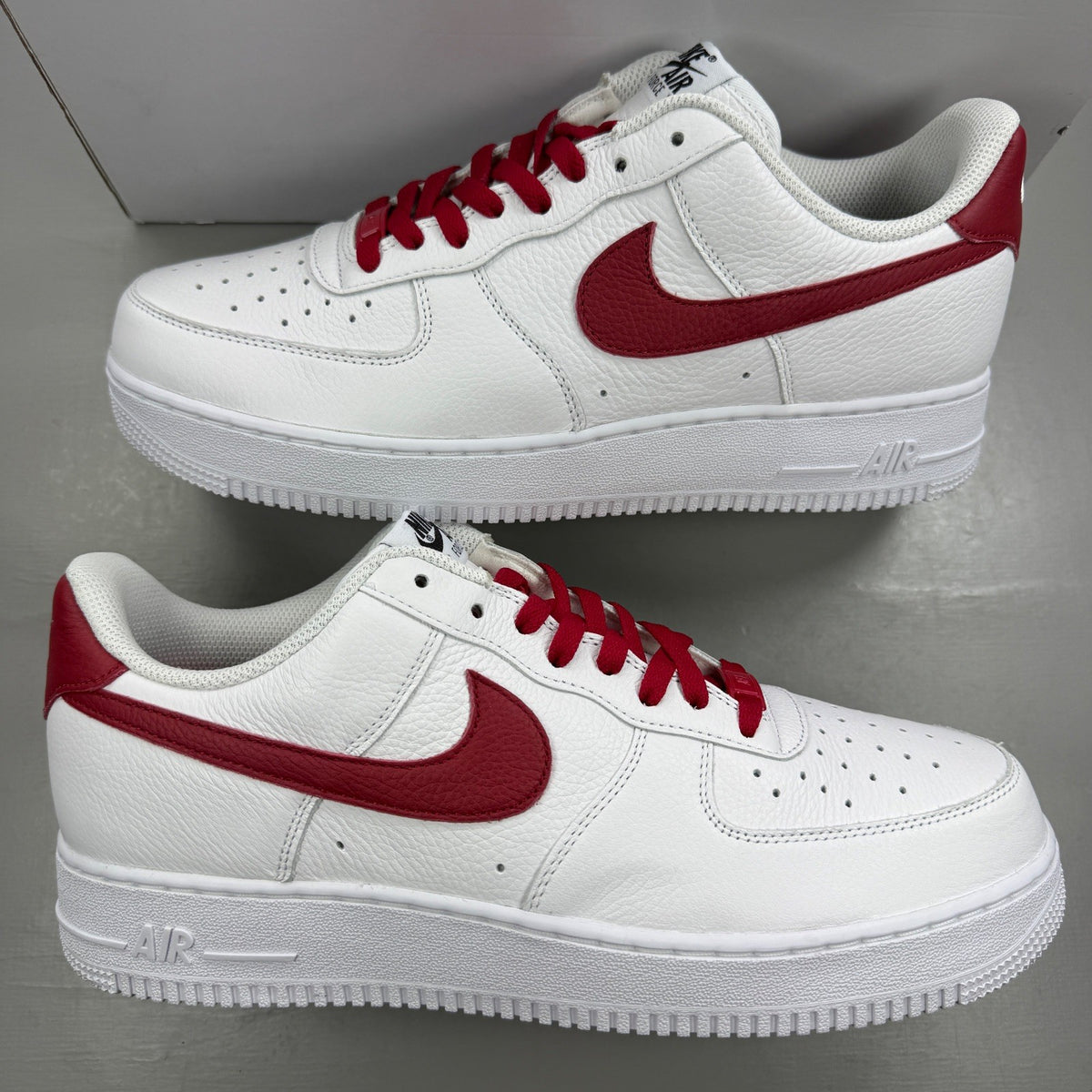 Nike deck shoes white leather with red accents and logo detail.
