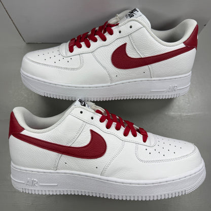 Nike deck shoes white leather with red accents and logo detail.