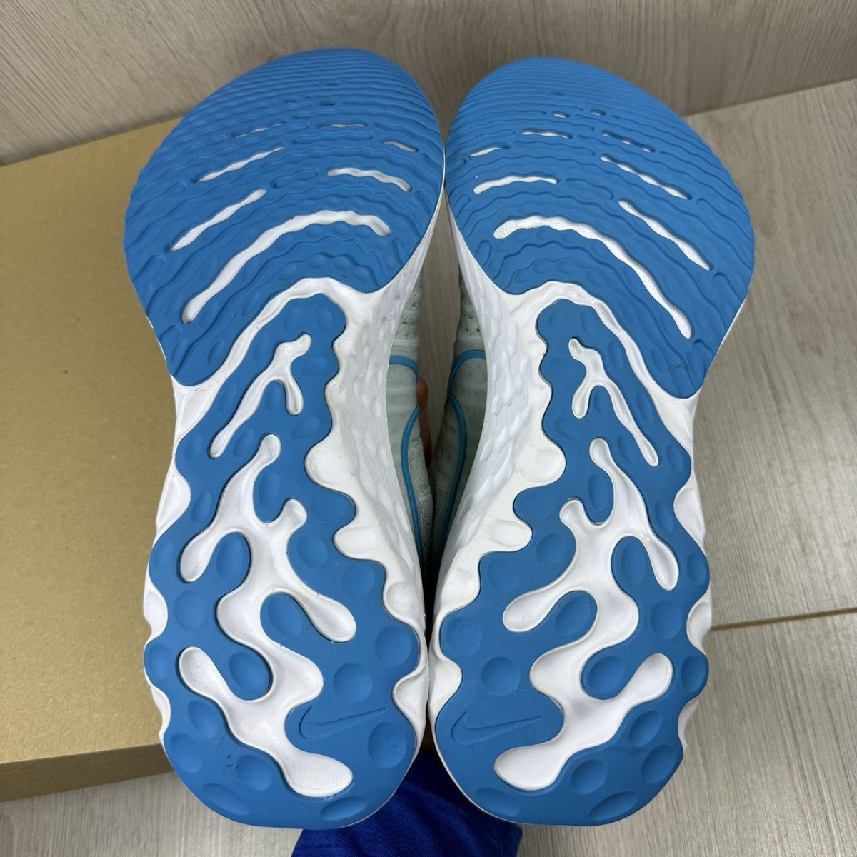 Nike React Infinity Run Flyknit 2 trainers blue grey white with Flyknit upper and logo.