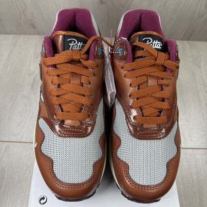 Nike Air Max 1 brown trainers with unique Patta logo and premium suede material.