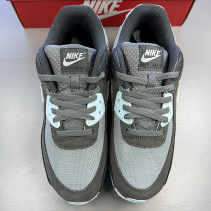 Nike Air Max 90 grey trainers with blue and white accents, featuring iconic logo.