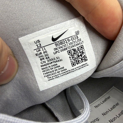 Nike running shoes grey mesh upper with white sole and logo detail.