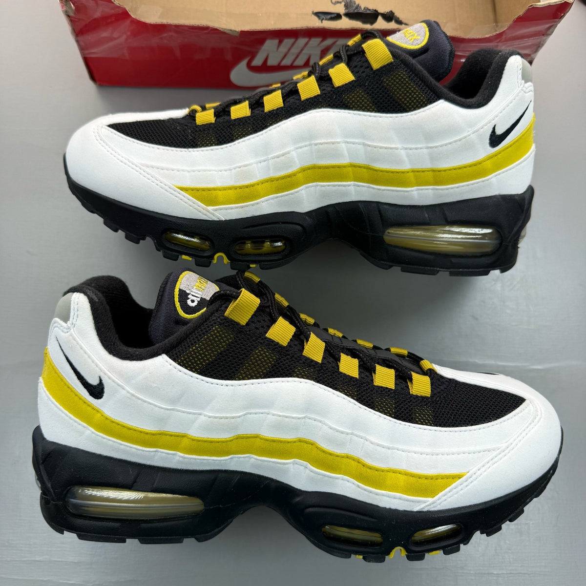 Nike Air Max 95 white trainers with big bubble sole and logo detail.