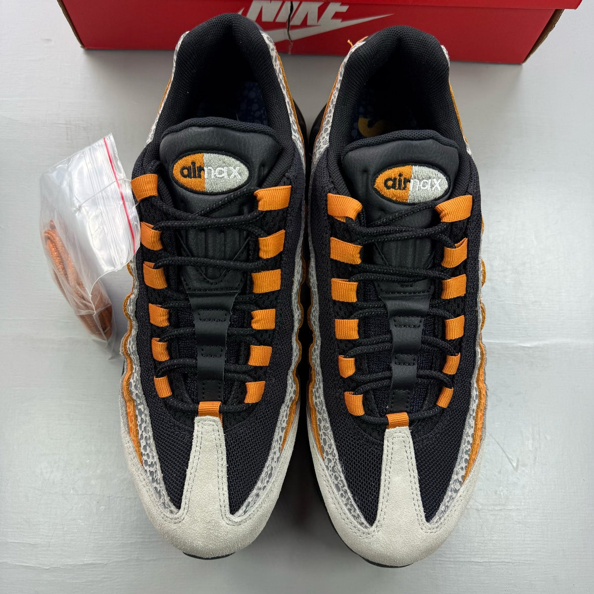 Nike Air Max 95 black trainers featuring unique safari print and signature logo.