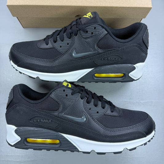 Nike trainers black with yellow accents and jewel detailing, featuring iconic swoosh logo.