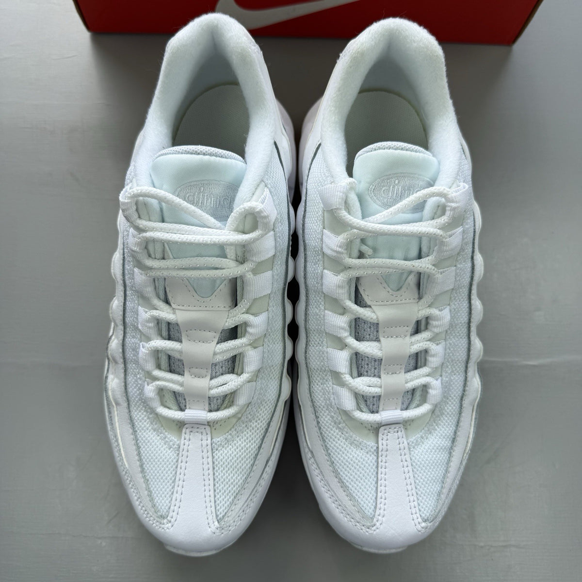 Nike Air Max 95 Recraft white trainers with distinctive layered design and air cushioning.