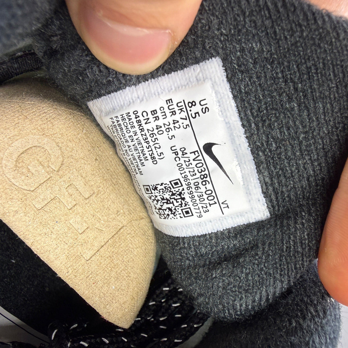 Nike deck shoes black with grey accents and gum sole, featuring iconic logo.