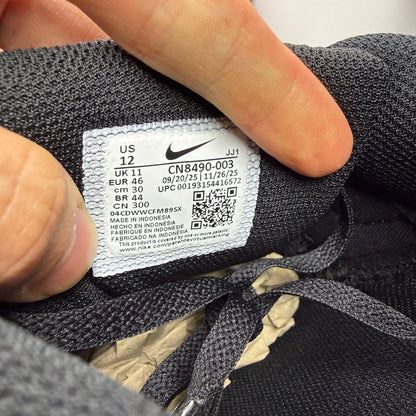 Nike Air Max 90 trainers black with logo detailing and sleek design.