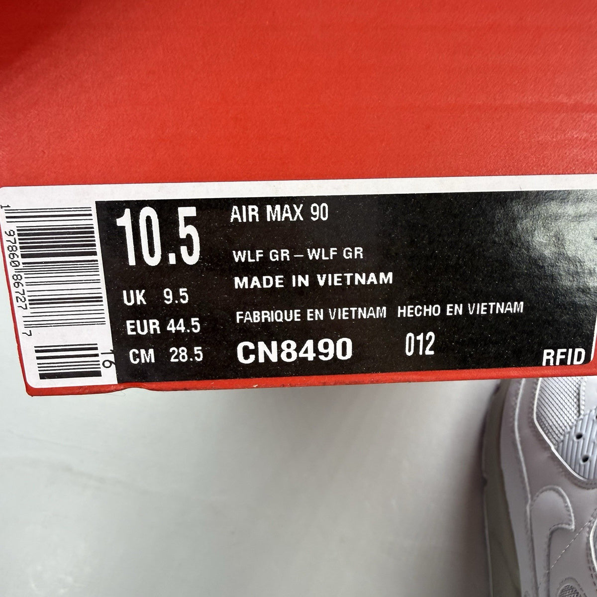 Nike Air Max 90 Recraft grey trainers with iconic swoosh logo and mesh detailing.