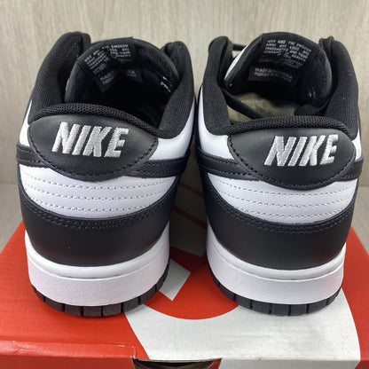 Nike Dunk Low trainers black and white with iconic swoosh logo and smooth leather upper.