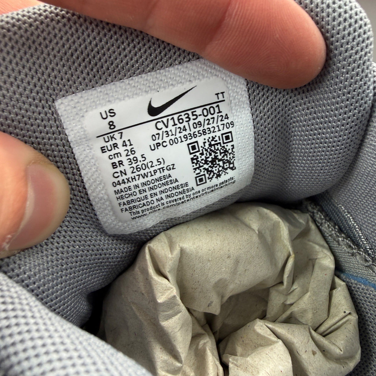 Nike trainers grey with aqua accents and retro logo detailing.