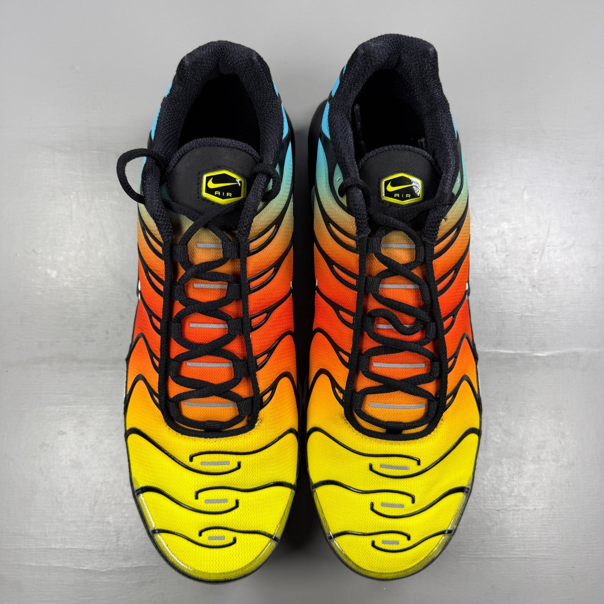 Nike running shoes blue with safety orange accents and signature logo.
