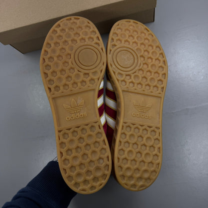 Adidas red athletic shoes with white stripes and gum sole, size UK 7.5.