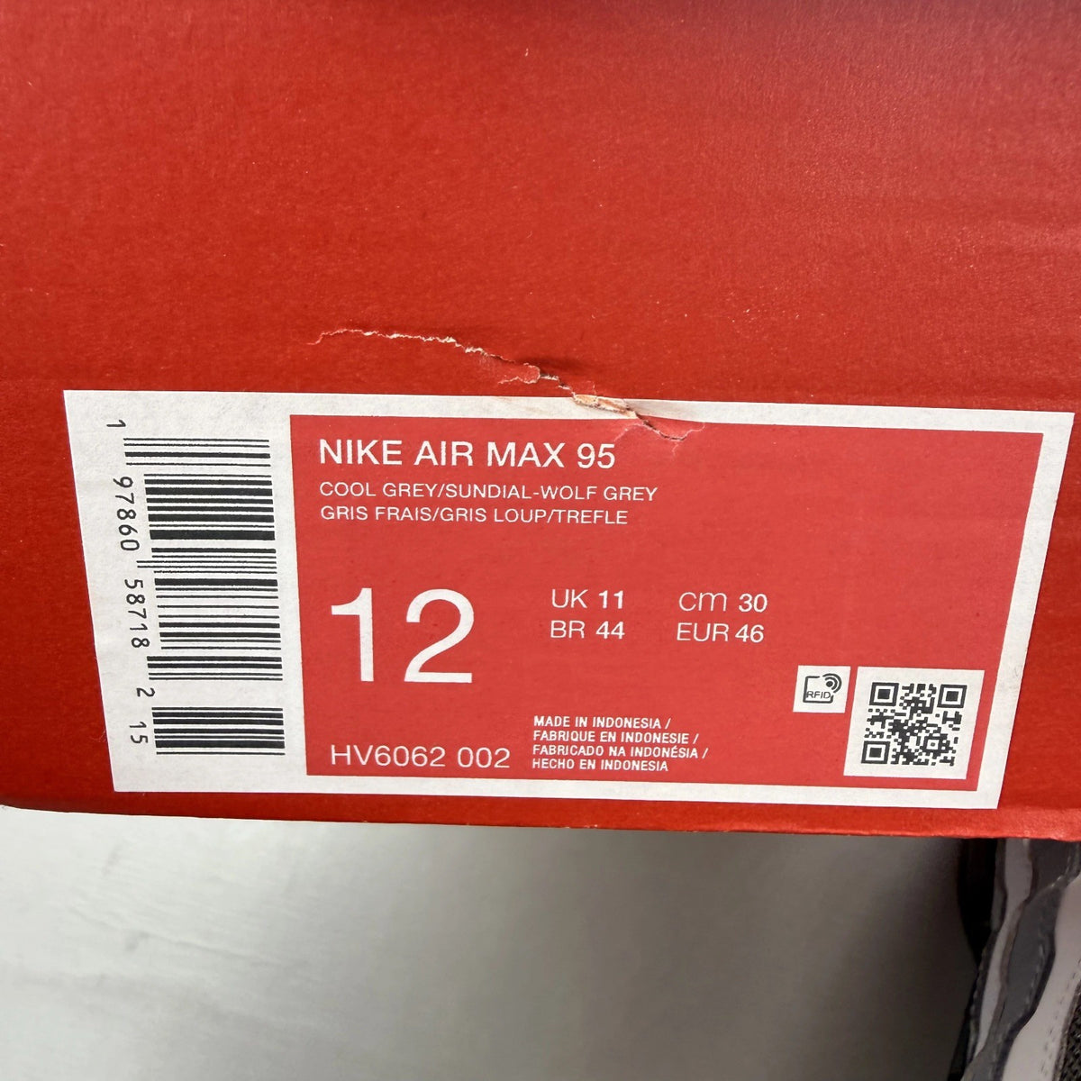 Nike Air Max 95 grey trainers with sundial accents and signature logo details.