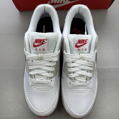 Nike Air Max 90 white trainers with black and red accents, featuring iconic logo and design.