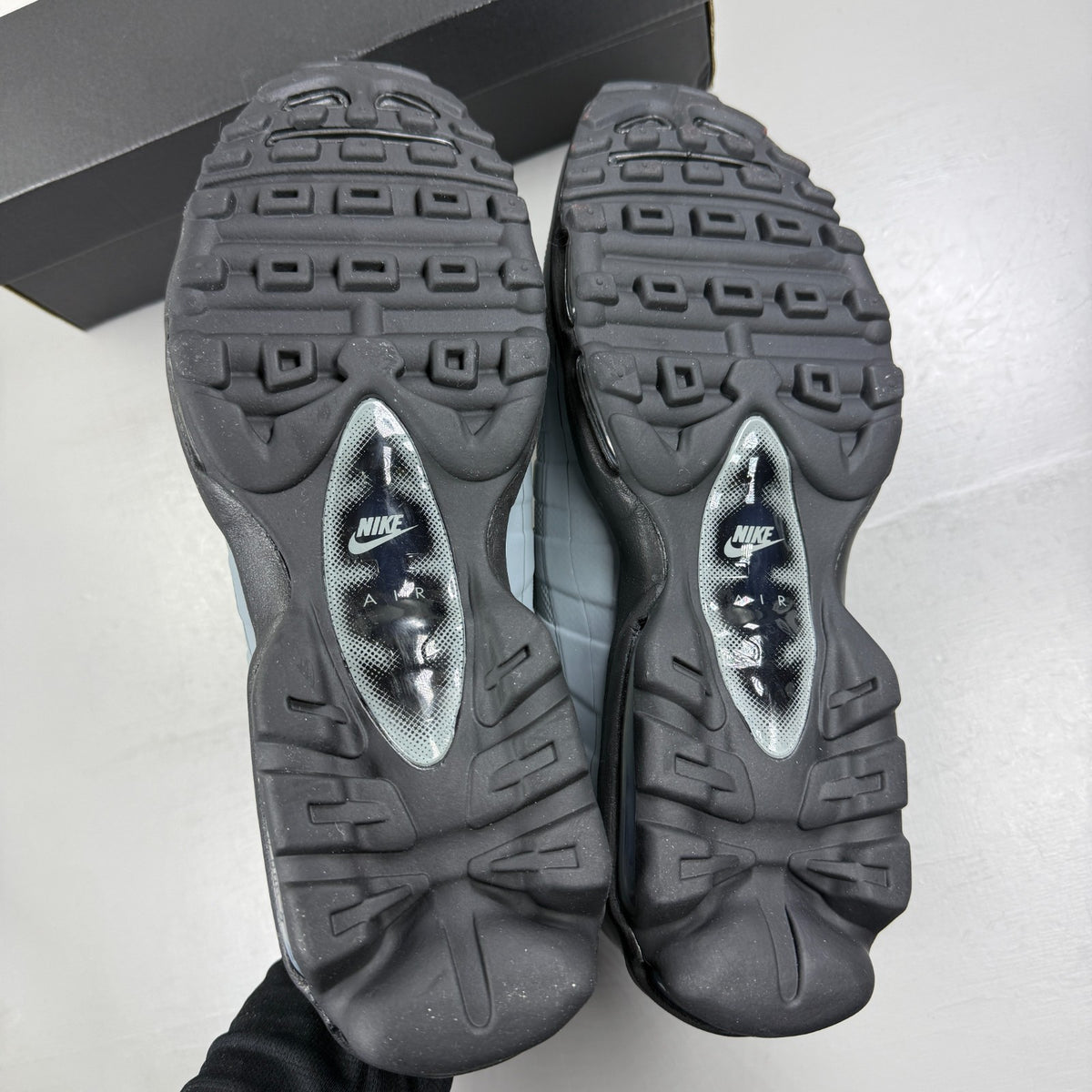 Nike running shoes grey with caution strip detailing and Air Max cushioning.