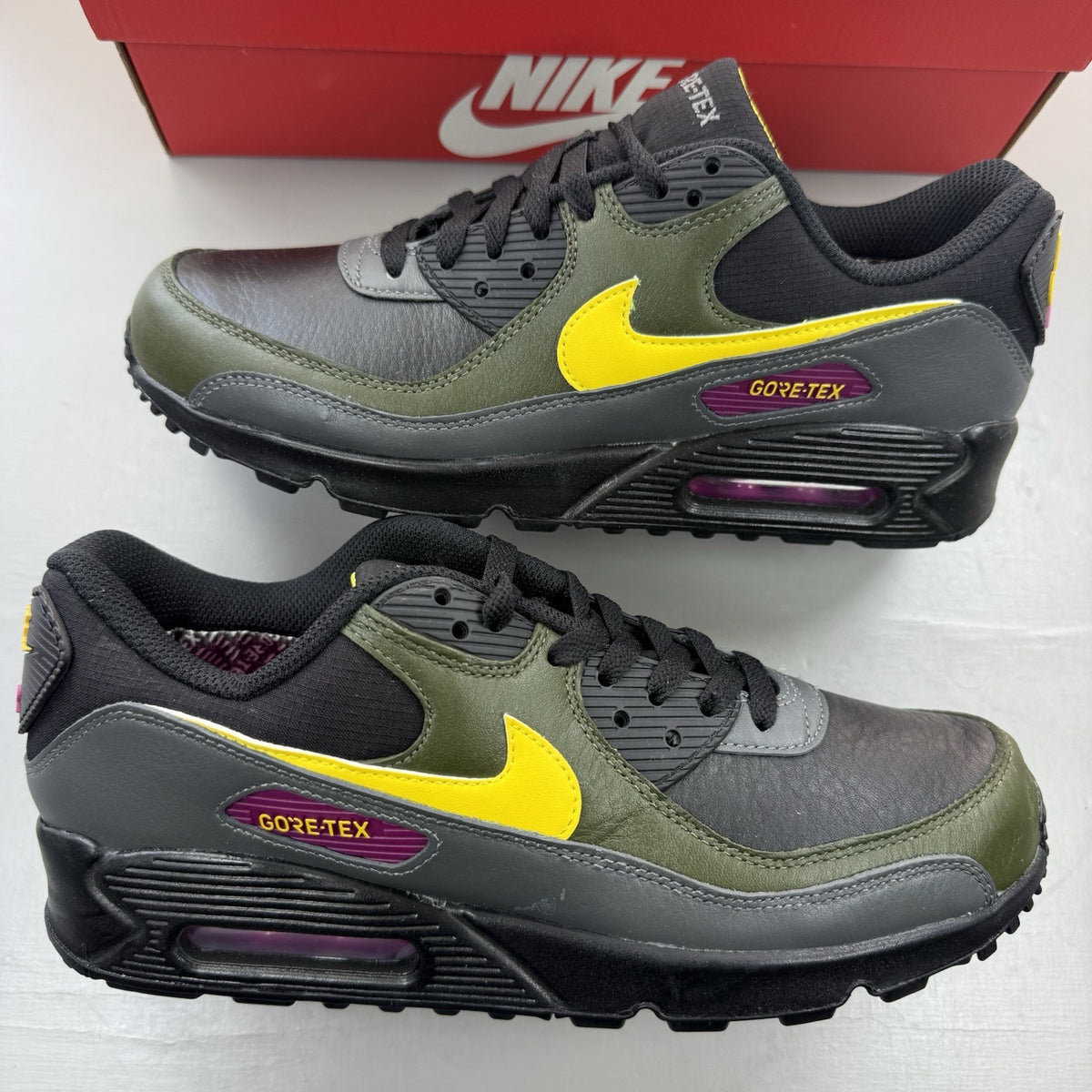 Nike Air Max 90 trainers black with Gore-Tex material and cargo khaki accents.