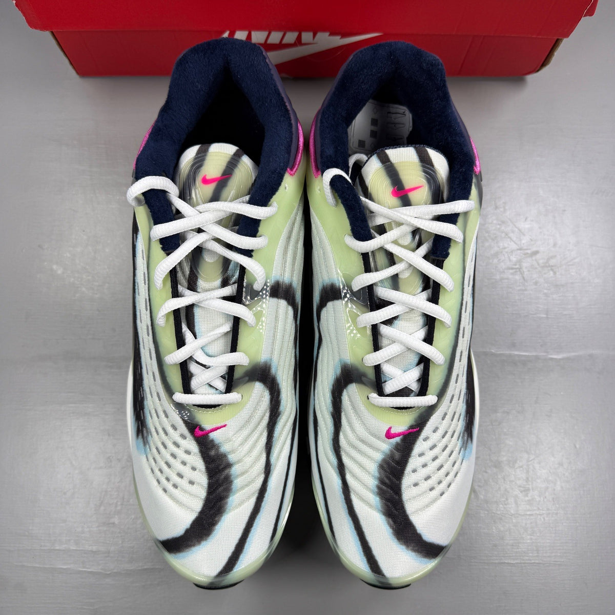 Nike trainers white with enamel green and silver accents, featuring unique design details.