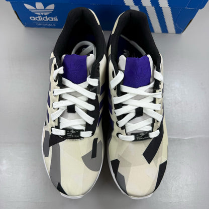 Adidas ZX Flux white trainers with purple and black accents, featuring iconic three-stripe logo.