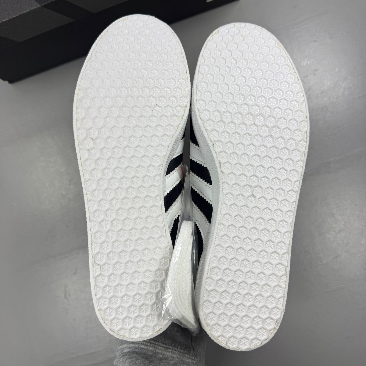 Adidas black athletic shoes with white stripes and logo, size UK 7.5.