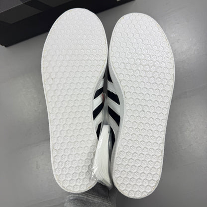 Adidas black athletic shoes with white stripes and logo, size UK 7.5.