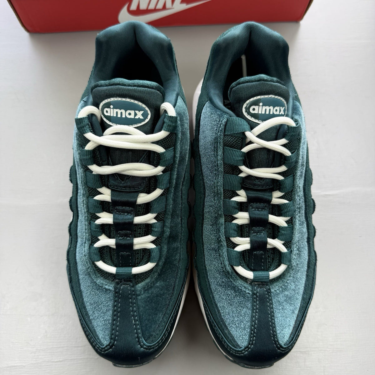 Nike Air Max 95 green velvet trainers with teal accents and white sole.