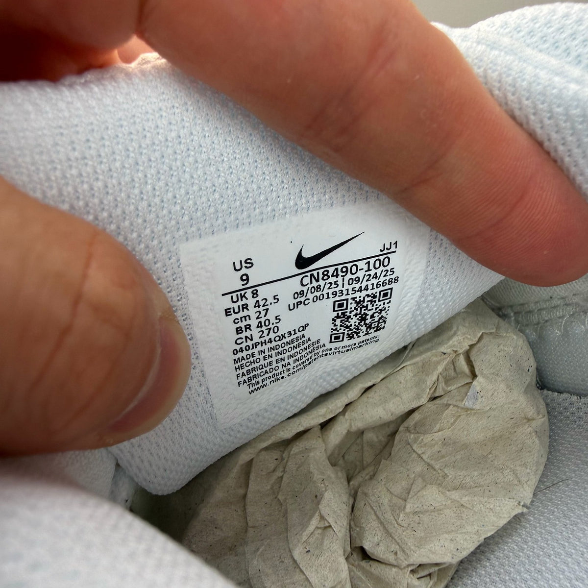 Nike Air Max 90 white trainers with iconic swoosh logo and breathable mesh material.