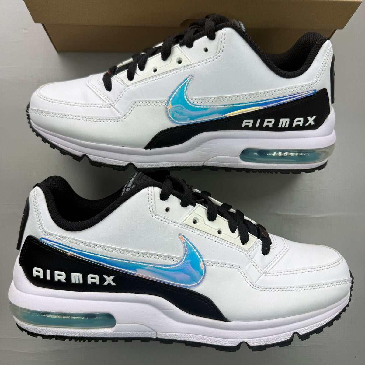 Nike Air Max LTD 3 white trainers with blue gaze and turquoise accents, featuring logo details.
